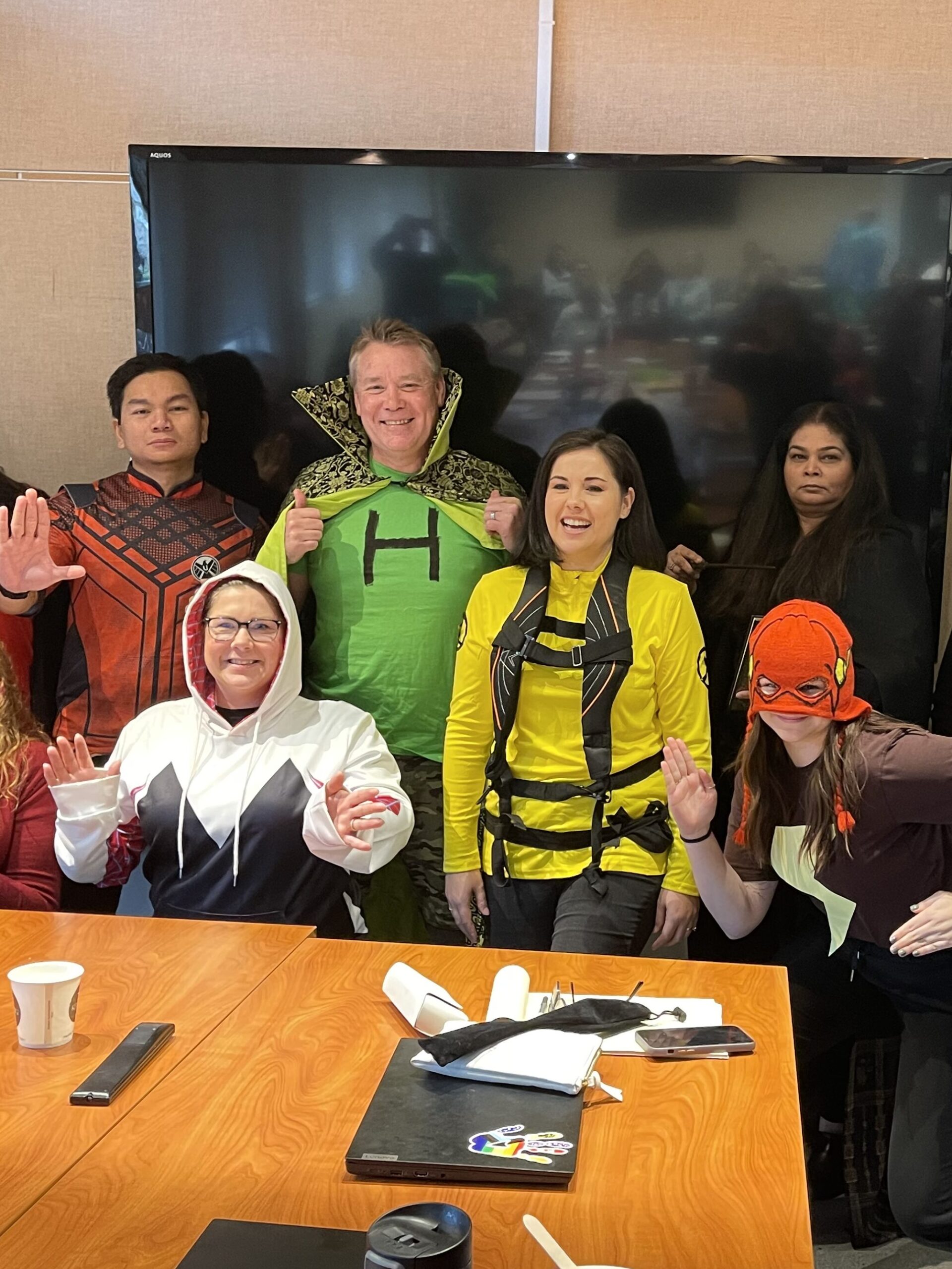 The Director team poses for a photo dressed as Superheroes, the theme for the round of accreditation that kicked off in 2023.