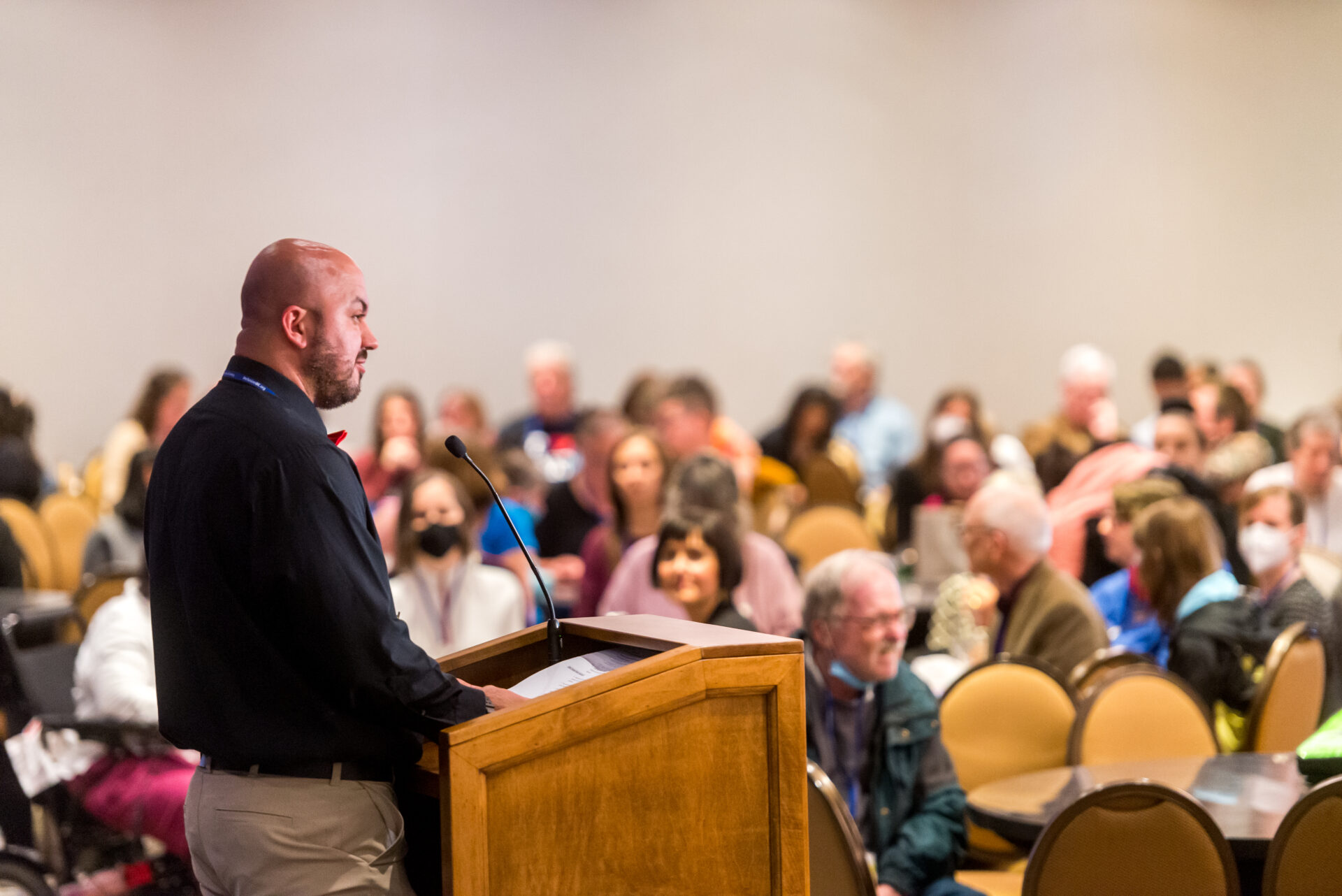 Board Member Alex Magnusson presents to the crowd at the Inclusion BC conference 2022.