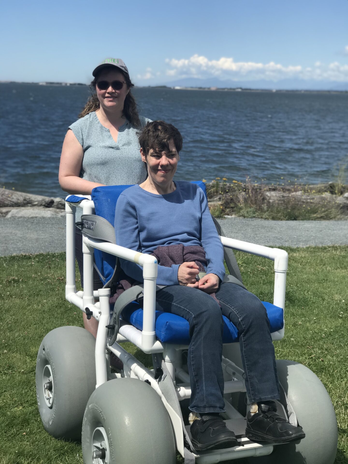 Alexa and Jen of the Self Advocates of Semiahmoo try out the beach wheelchair at Crescent Beach.