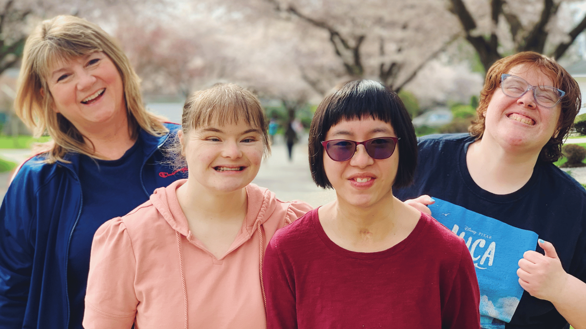 Uniti women together with cherry blossoms